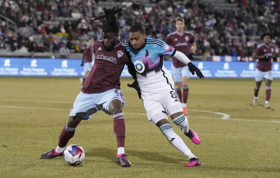 Colorado Rapids defender Lalas Abubakar, left, fights for control of the ball with Minnesota United midfielder Joseph Rosales during the second half of an MLS soccer match Saturday, March 18, 2023, in Commerce City, Colo. (AP Photo/David Zalubowski)