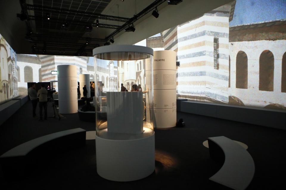 View of the Palmyra Exhibit, a three-dimensional projection featuring never-before-seen images of Palmyra taken by a drone in April after the city was liberated from IS fighters, at Grand Palais in Paris, Tuesday, Dec.13, 2016. As Islamic State extremists recapture the ancient Syrian city of Palmyra, the French president and the UNESCO chief are inaugurating an exhibit in Paris to educate the public about the wonders of endangered UNESCO heritage sites in Palmyra and the Middle East. (AP Photo/Francois Mori)