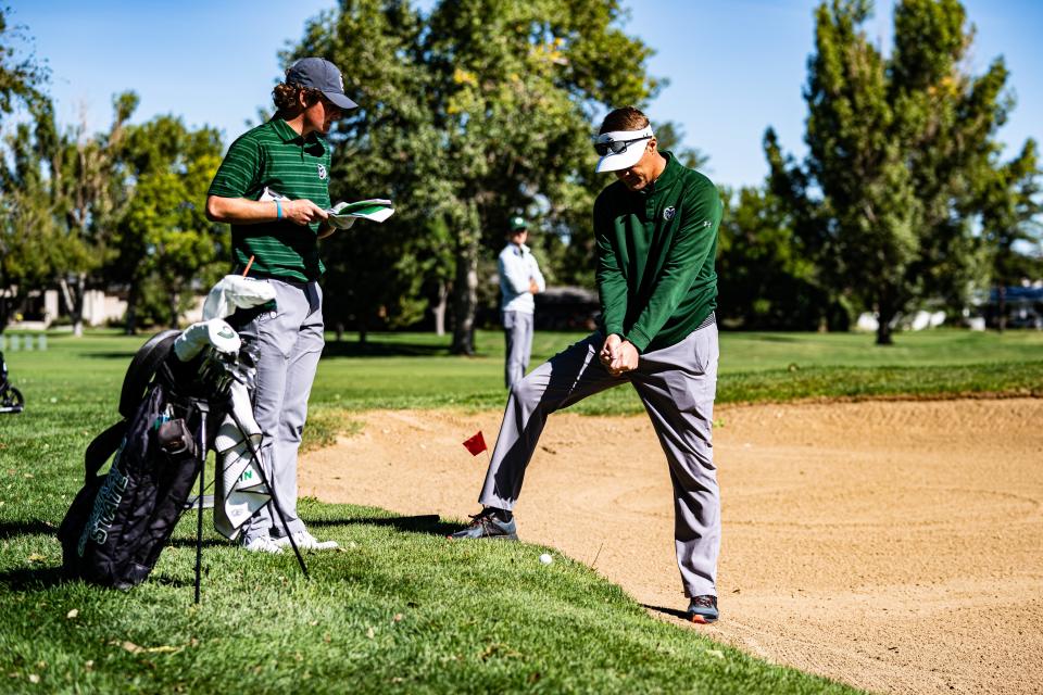 Colorado State men's golf coach Christian Newton, right, helps Connor Jones prepare for a shot during the Ram Masters Invitational Sept. 20-21, 2021, at Fort Collins (Colo.) Country Club.