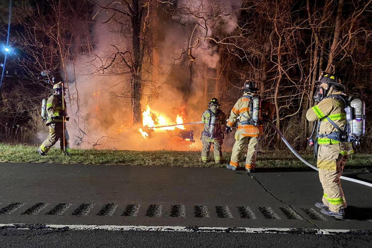 Firefighters work to extinguish a burning car in Brookfield, Conn., on Nov. 26, 2022. (Brookfield Volunteer Fire Compan)