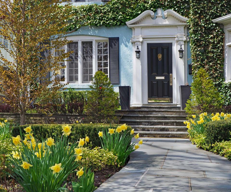 front yard with spring flowers and path