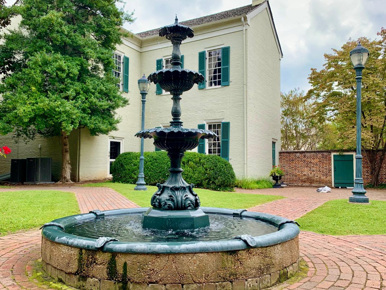 An image of the fountain located at the James K. Polk Home's scenic gardens.