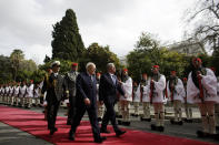 Greek President Karolos Papoulias, third from left, and his German counterpart Joachim Gauck, right, inspect a presidential guard during an official welcome ceremony outside the presidential palace, in Athens , on Thursday, March 6, 2014. Gauck is on a visit that will seek to lay to rest some of the ghosts of a brutal Nazi occupation, amid renewed anti-German sentiment stoked by Greece's financial crisis. His three-day visit will include a speech Friday at a site where German army troops massacred 92 villagers near the northeastern town of Ioannina, and a meeting with the town's Jewish community. (AP Photo/Kostas Tsironis)