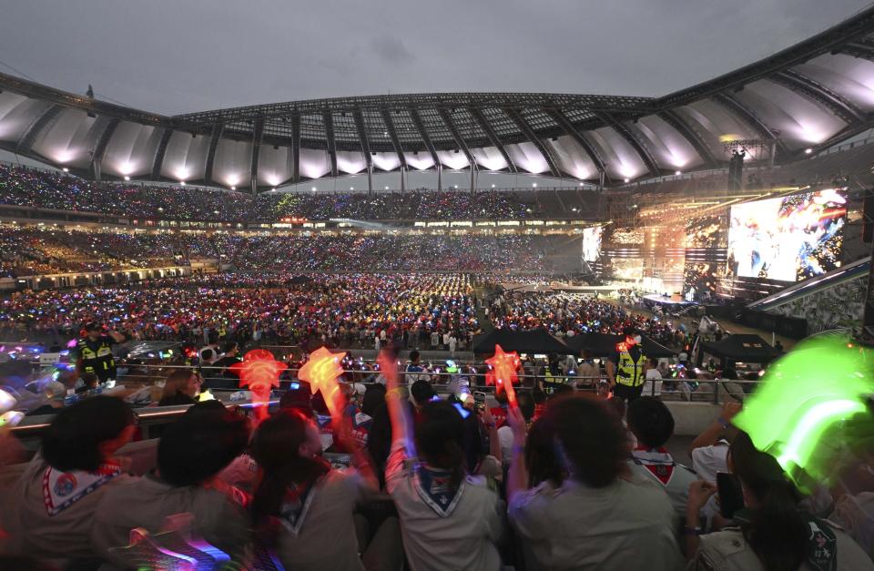 Attendees of the World Scout Jamboree watch a K-Pop concert after the closing ceremony of the World Scout Jamboree at the World Cup Stadium in Seoul, South Korea, Friday, Aug. 11, 2023. Flights and trains resumed and power was mostly restored Friday after a tropical storm blew through South Korea, which was preparing a pop concert for 40,000 Scouts whose global Jamboree was disrupted by the weather. (Korea Pool via AP)