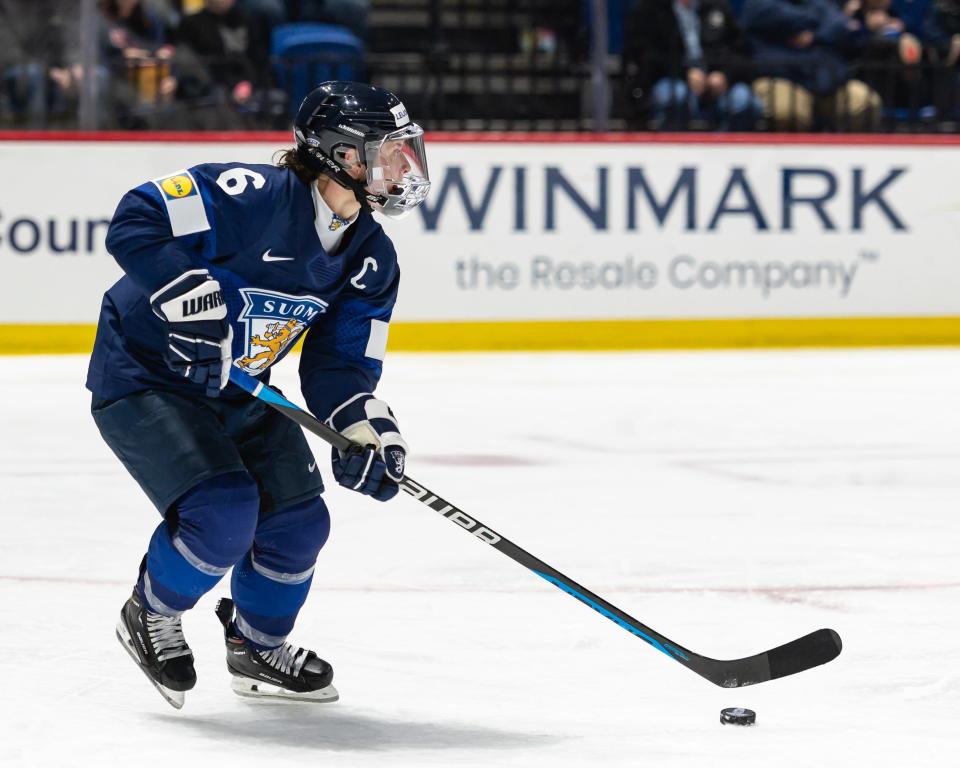 Finland's Jenni Hiirikoski advances the puck at the Adirondack Bank Center in Utica, NY on Saturday, April 6, 2024.