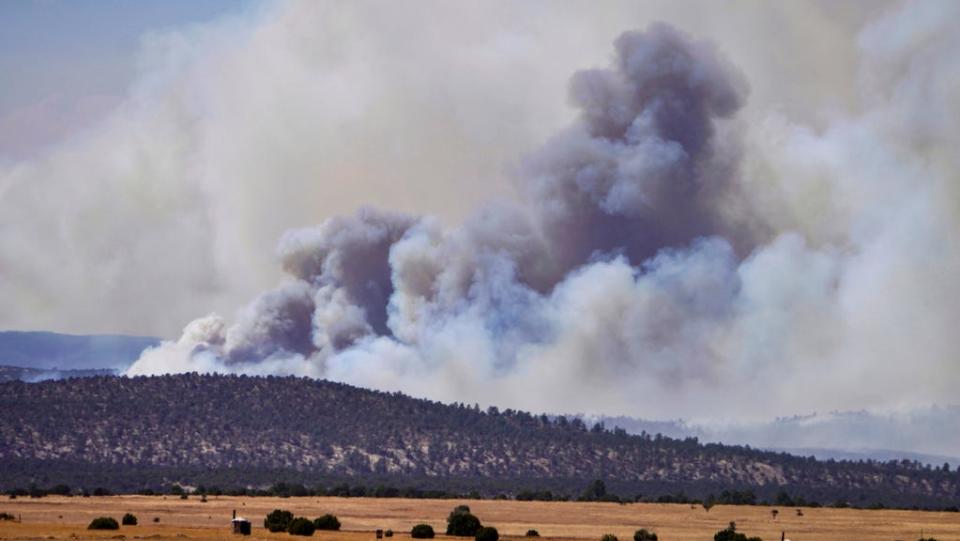 Smoke rises from wildfires near Las Vegas, N.M., Wednesday, May 4, 2022. Firefighters slowed the advance of the largest wildfire in the U.S. as heavy winds relented Wednesday, while President Joe Biden approved a disaster declaration that brings new financial resources to remote stretches of New Mexico devastated by fire since early April.