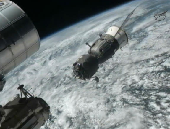 The Russian Soyuz TMA-03M backs away from the International Space Station after undocking to return three members of the Expedition 31 crew to Earth on July 1, 2012, in this still from a NASA broadcast.