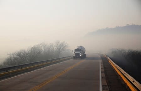 A tanker truck is seen in the area where wildfires have destroyed hectares of forest in Robore