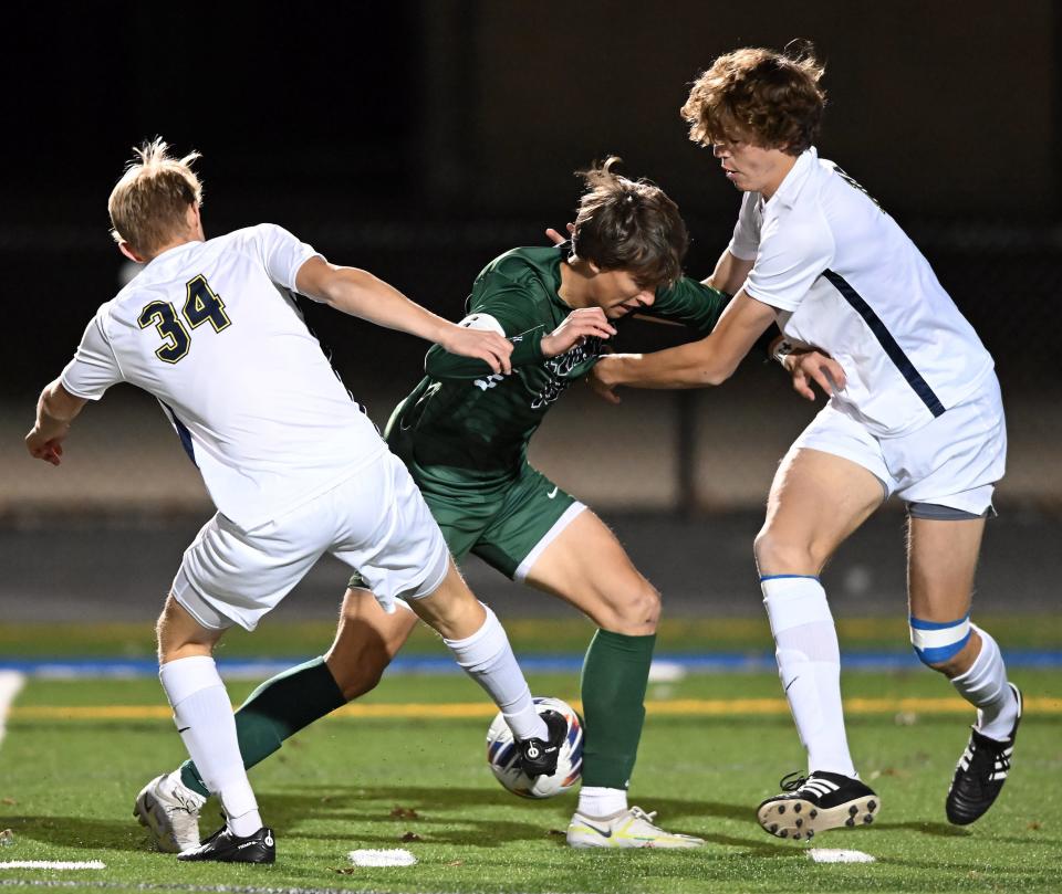 Medina's Cole Turchyn, center, has been voted one of the best boys soccer players in the state of Ohio in 2023.