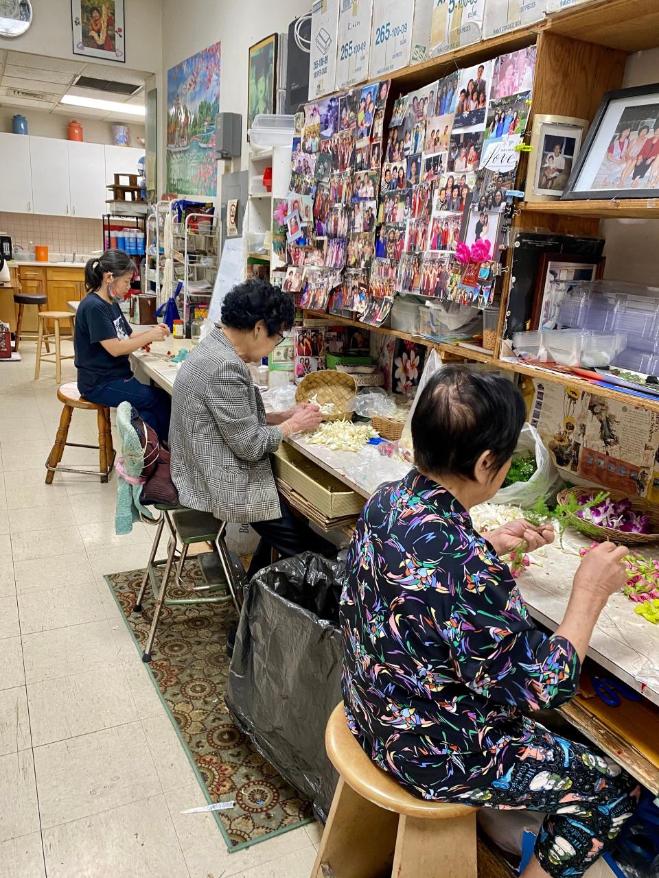 Women string flower garlands at Cindy's Lei Shoppe, in Honolulu's Chinatown. Cindy, who founded the store more than 60 years ago, sits in the middle.