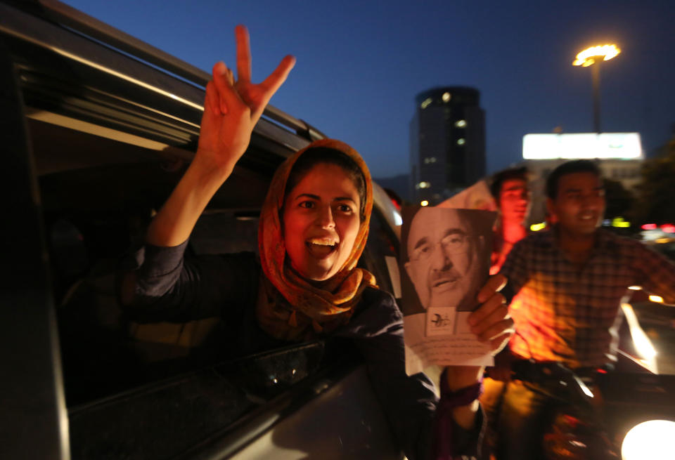 An Iranian woman celebrates the victory of moderate presidential candidate Hassan Rouhani in the presidential elections at Vanak Square, in northern Tehran, on June 15, 2013. (ATTA KENARE/AFP/Getty Images)