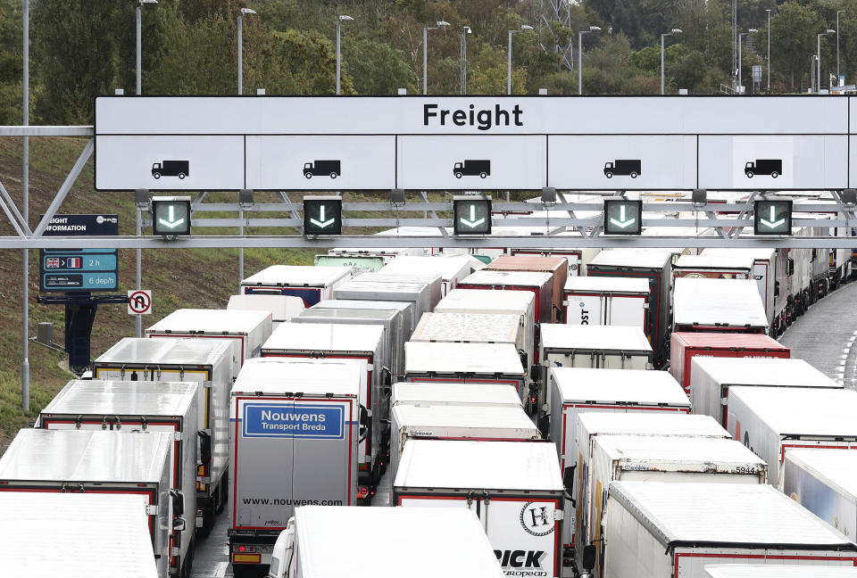 A view of lorries queuing for the Eurotunnel in Folkestone, Kent, England, Friday, Sept. 25, 2020, as the government develops the 27-acre site near Ashford into a post-Brexit lorry park as it gears up to leave the EU at the end of the year. (Gareth Fuller/PA via AP)