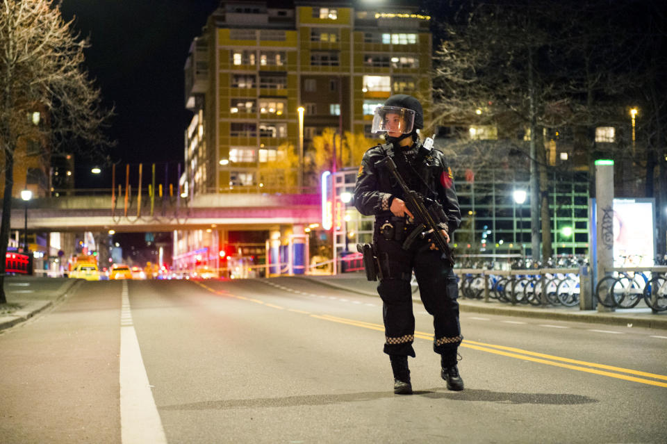 An officer stands guard as police cordon off a large area around a subway station on a busy commercial street Saturday night, April 8, 2017, after finding what they described as a "bomb-like" device, in Oslo, Norway. The official police Twitter account said one man has been arrested and Police Chief Vidar Pedersen said police were working to disarm it. (Fredrik Varfjell /NTB scanpix via AP)