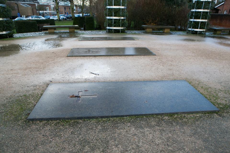 Three graves stones mark the site where Hyde Abbey once stood in Winchester, England, Friday Jan. 17, 2014. Researchers said Friday they may have discovered remains of King Alfred the Great, the 9th-century royal remembered for protecting England from the Vikings and educating a largely illiterate nation. Alfred's bones are known to have been moved after he died, eventually being deposited at Hyde Abbey in Winchester, about 65 miles (100 kilometers) southwest of London. (AP Photo/PA, Steve Parsons) UNITED KINGDOM OUT NO SALES NO ARCHIVE