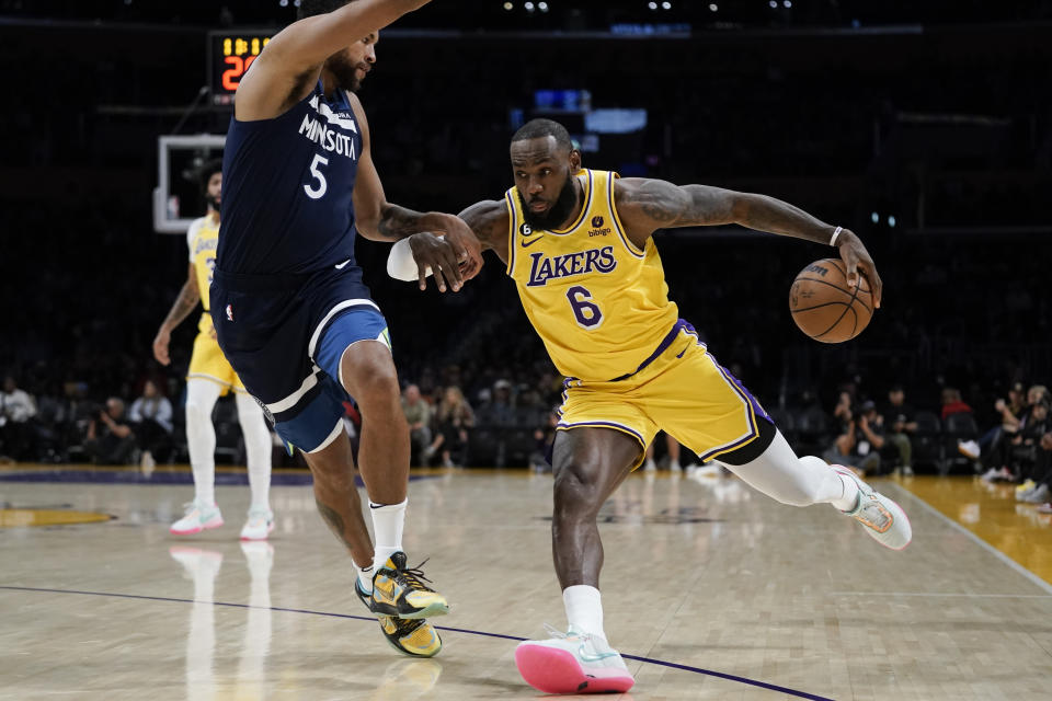 Los Angeles Lakers' LeBron James, right, drives against Minnesota Timberwolves' Kyle Anderson during first half of an NBA preseason basketball game Wednesday, Oct. 12, 2022, in Los Angeles. (AP Photo/Jae C. Hong)