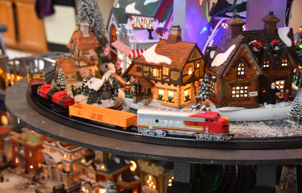 A model train rounds a bend at Willard Davis' Christmas model train village at his Suntree home.