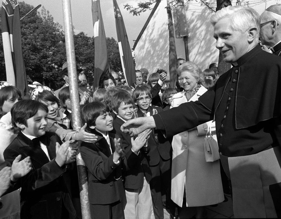 FILE - Archbishop of Munich and Freising Joseph Ratzinger greets faithful in front of the Ramersdorfer Marienkirche (church Mary) after being nominated archbishop on May 23, 1977. Ratzinger went on to become Pope Benedict XVI. Pope Emeritus Benedict XVI, the German theologian who will be remembered as the first pope in 600 years to resign, has died, the Vatican announced Saturday. He was 95. (AP Photo/Dieter Endlicher, File)