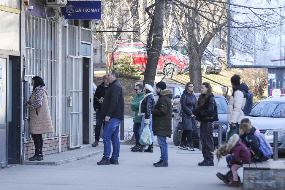 People line up at a cash machine in northern Serb-dominated part of ethnically divided town of Mitrovica, Kosovo, Thursday, Feb. 1, 2024. The European Union on Thursday called on Kosovo to postpone an effort to force ethnic Serbian-dominated areas to adopt the same currency as the rest of the country, as rules that would block use of the Serbian dinar went into effect. Most of Kosovo uses the Euro, even though the country is not part of the EU, but parts of its north populated mostly by ethnic Serbs continue to use the dinar. (AP Photo/Bojan Slavkovic)