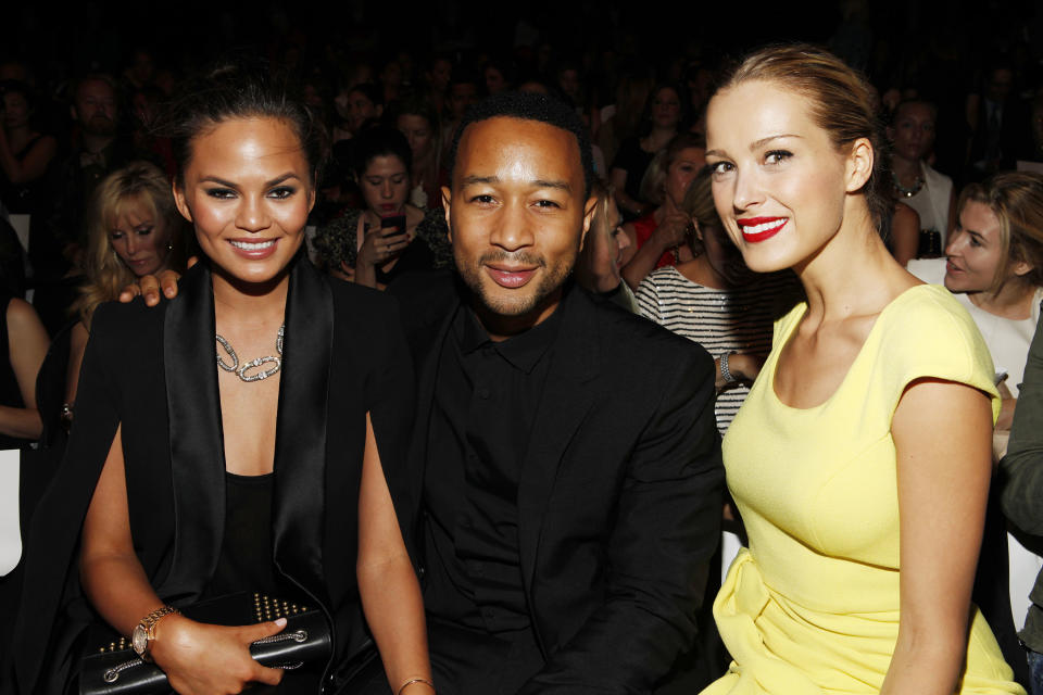 Chrissy Teigen, from left, John Legend and Petra Nemcova attend the Badgley Mischka Spring 2014 collection on Tuesday, Sept. 10, 2013, during Mercedes-Benz Fashion Week in New York. (Photo by Amy Sussman/Invision/AP)