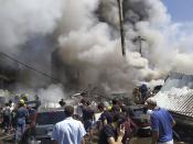 Smoke rises from Surmalu market about two kilometers (1.2 miles) south of the center Yerevan, Armenia, Sunday, Aug. 14, 2022. A strong explosion hit a large market in the capital of Armenia on Sunday, setting off a fire and reportedly trapping people under rubble. The Interfax news agency cited Armenia's emergency service as saying the explosion occurred in a building at the Surmalu market where fireworks were sold. (AP Photo/Daniel Bolshakov)