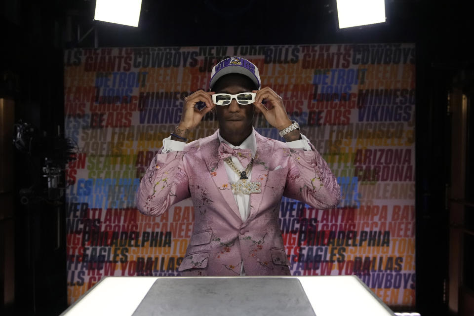 Southern California wide receiver Jordan Addison adjusts his glasses after being chosen by the Minnesota Vikings with the 23rd overall pick during the first round of the NFL football draft, Thursday, April 27, 2023, in Kansas City, Mo. (AP Photo/John Locher)