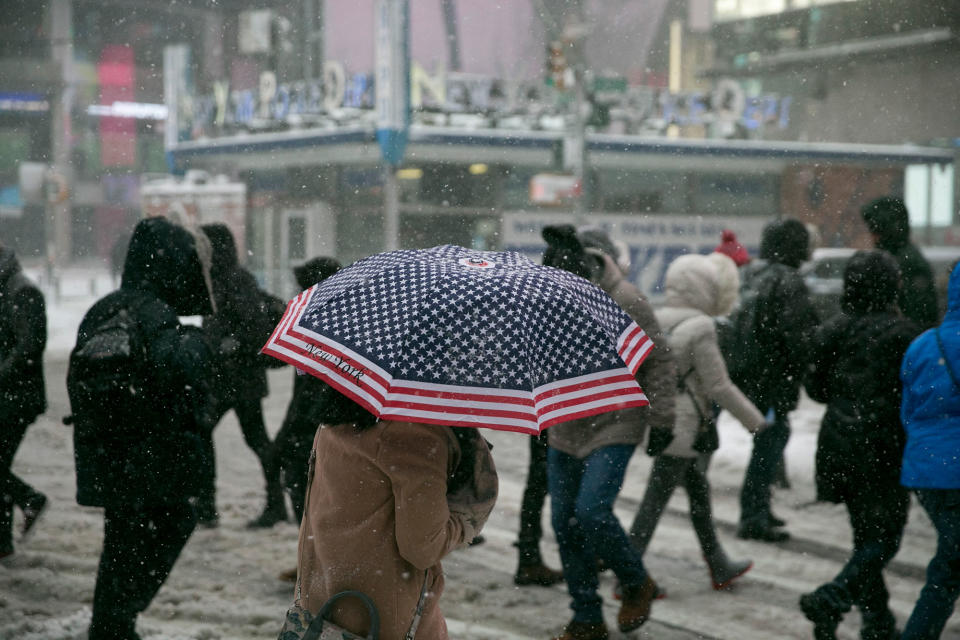 <p>A woman carries an U.S. flag umbrella in Times Square during a winter storm in New York, Feb. 9, 2017. A powerful, fast-moving storm swept through the northeastern U.S., making for a slippery morning commute and leaving some residents bracing for blizzard conditions. (Gordon Donovan/Yahoo News) </p>