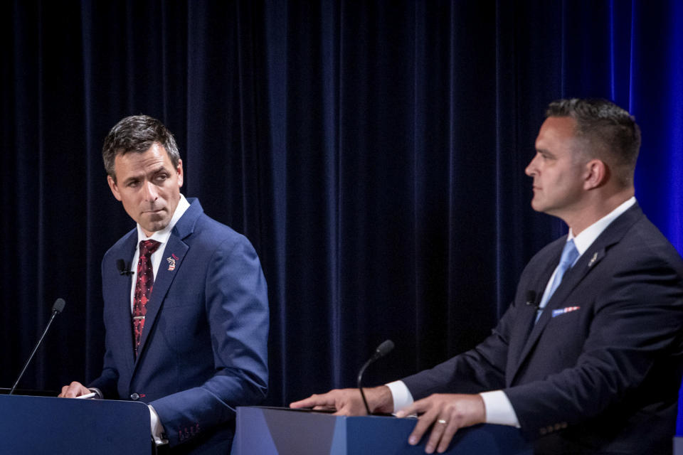 Michigan Republican candidates for governor Ryan Kelley, of Allendale, left, and Garrett Soldano, of Mattawan, appear at a debate in Grand Rapids, Mich., Wednesday, July 6, 2022. (Michael Buck/WOOD TV8 via AP)