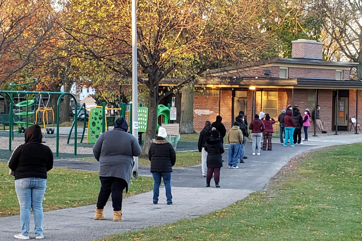 Voters wait in line outside a pavilion at Center Street Park shortly before the polling site opened on Election Day, Nov. 3, 2020, in Milwaukee. (AP Photo/Rich Rovito)