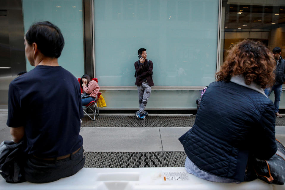 Customers wait in line for the new iPhone X outside an Apple store in New York