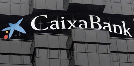 Caixabank's logo is seen on top of the company's headquarters in Barcelona, October 26, 2012. REUTERS/Albert Gea