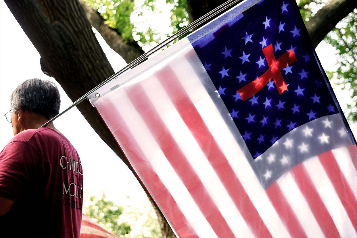 A United States and Christian flag are sandwiched together Chip Somodevilla/Getty Images