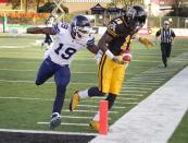 Hamilton Tiger-Cats' Dobson Collins (R) is pushed out of bounds just shy of the touchdown marker by Toronto Argonauts' Jalil Carter in the first half of their CFL football game in Guelph October 14, 2013. REUTERS/Fred Thornhill (CANADA - Tags: SPORT FOOTBALL)