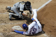 Chicago Cubs' Willson Contreras, bottom, scores on a one-run double by Kyle Schwarber as Pittsburgh Pirates catcher Jacob Stallings misses the catch during the fifth inning of a baseball game in Chicago, Sunday, Aug. 2, 2020. (AP Photo/Nam Y. Huh)