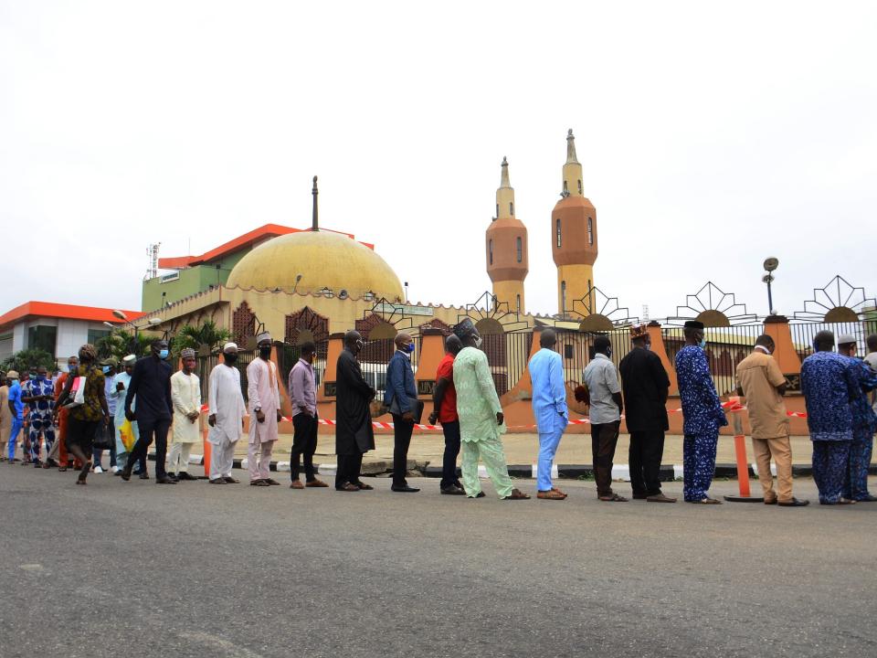 Worshippers wearing protective facemasks stay in line maintain the required social distance during the first Friday prayer outside The Lagos State Secretariat Central Mosque in Lagos on August 7, 2020, After a five months break as a measure against the coronavirus (COVID-19) pandemic mosques are re-opened across the state for congregational prayers on a decision from the state government. (Photo by Olukayode Jaiyeola/NurPhoto via Getty Images)