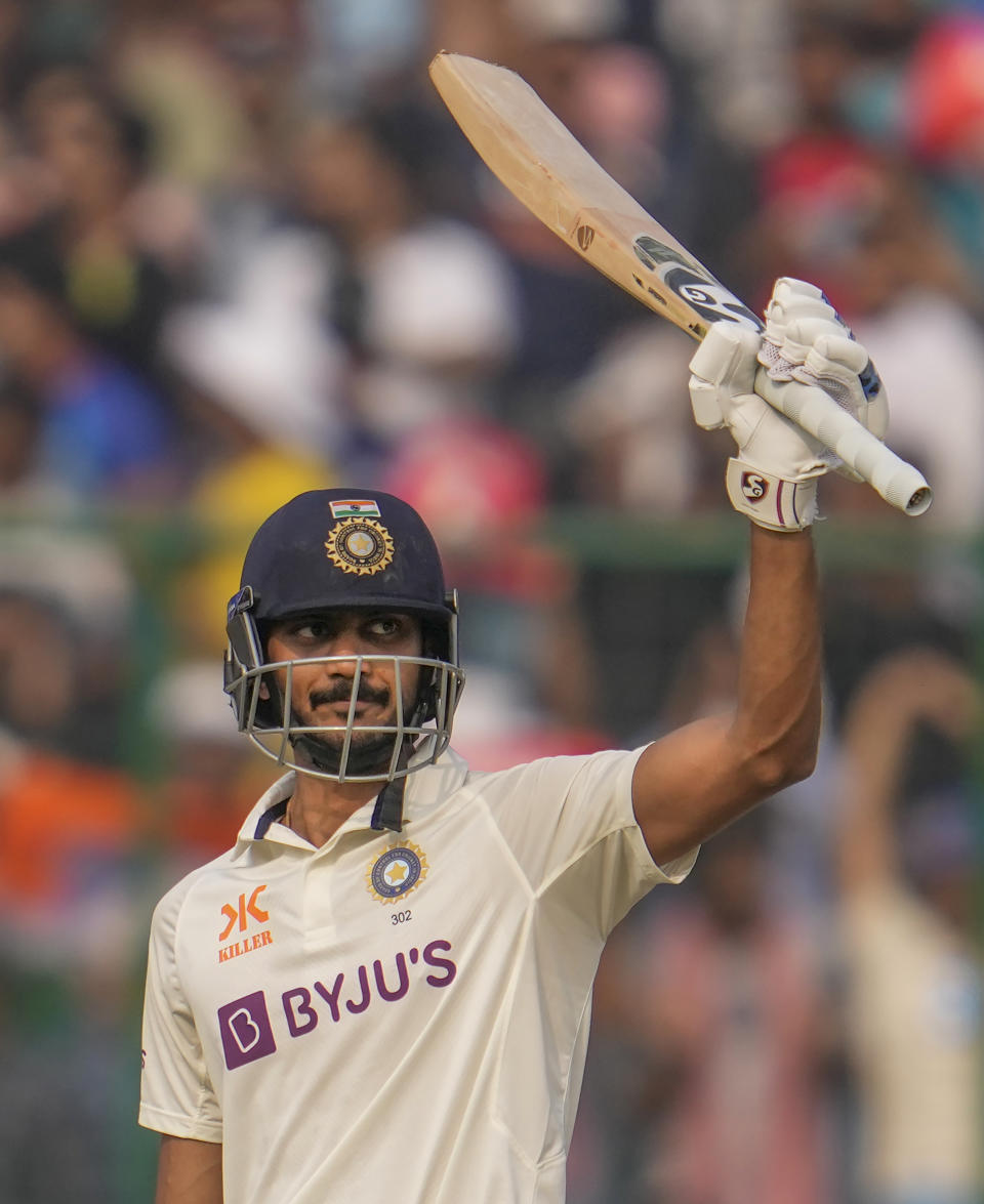 India's Axar Patel raises his bat to celebrate scoring a half century during the second day of the second cricket test match between India and Australia in New Delhi, India, Saturday, Feb. 18, 2023. (AP Photo/Altaf Qadri)