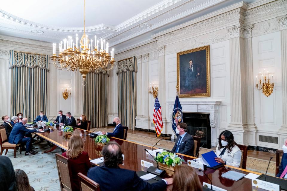 President Joe Biden holds a meeting in the State Dining Room of the White House