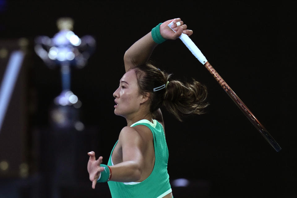 Zheng Qinwen of China plays a forehand return to Aryna Sabalenka of Belarus during the women's singles final at the Australian Open tennis championships at Melbourne Park, Melbourne, Australia, Saturday, Jan. 27, 2024. (AP Photo/Andy Wong)