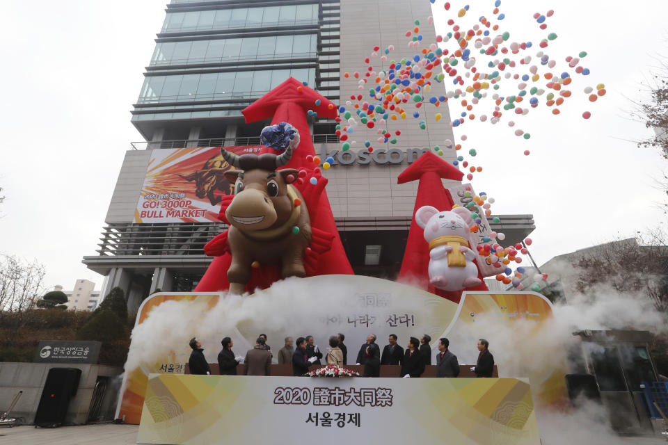 South Korean financial officers celebrate the opening of this year's trading in Seoul, South Korea, Thursday, Jan. 2, 2020. Asian shares were mostly higher on optimism about a U.S.-China trade deal as most of the region's markets opened the new year's first day of trading Thursday. (AP Photo/Ahn Young-joon)