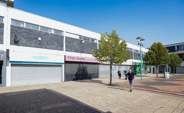 Shoppers walk through Huyton Village Shops, in Knowsley, Merseyside, many of which are closed, some six months on from the evening of March 23 when Prime Minister Boris Johnson announced nationwide restrictions 