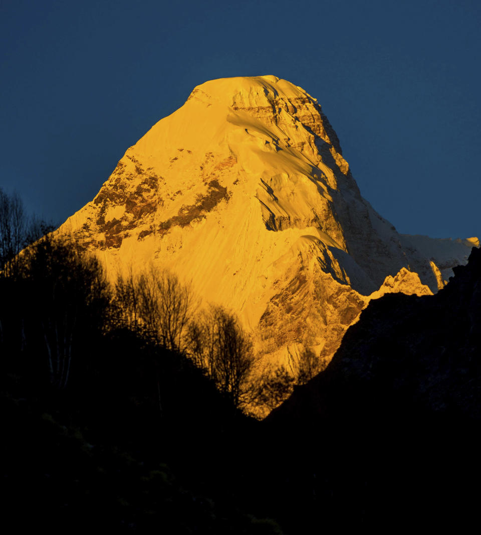 In this Oct. 8, 2016, photograph provided by Juniper Outdoor Pursuits Centre Pvt. Ltd., shows early morning light falling on Nanda Devi east base peak, seen from Pachu valley in Uttarakhand, India. Indian air force pilots have resumed a search over a Himalayan mountain for a team of mostly foreign climbers missing since late May. The fourth day of the search on Tuesday was taking place in the northern state of Uttarakhand after five bodies were spotted in the snow in high-resolution photos taken Monday. (Maninder Kohli/Juniper Outdoor Pursuits Centre Pvt. Ltd. via AP)