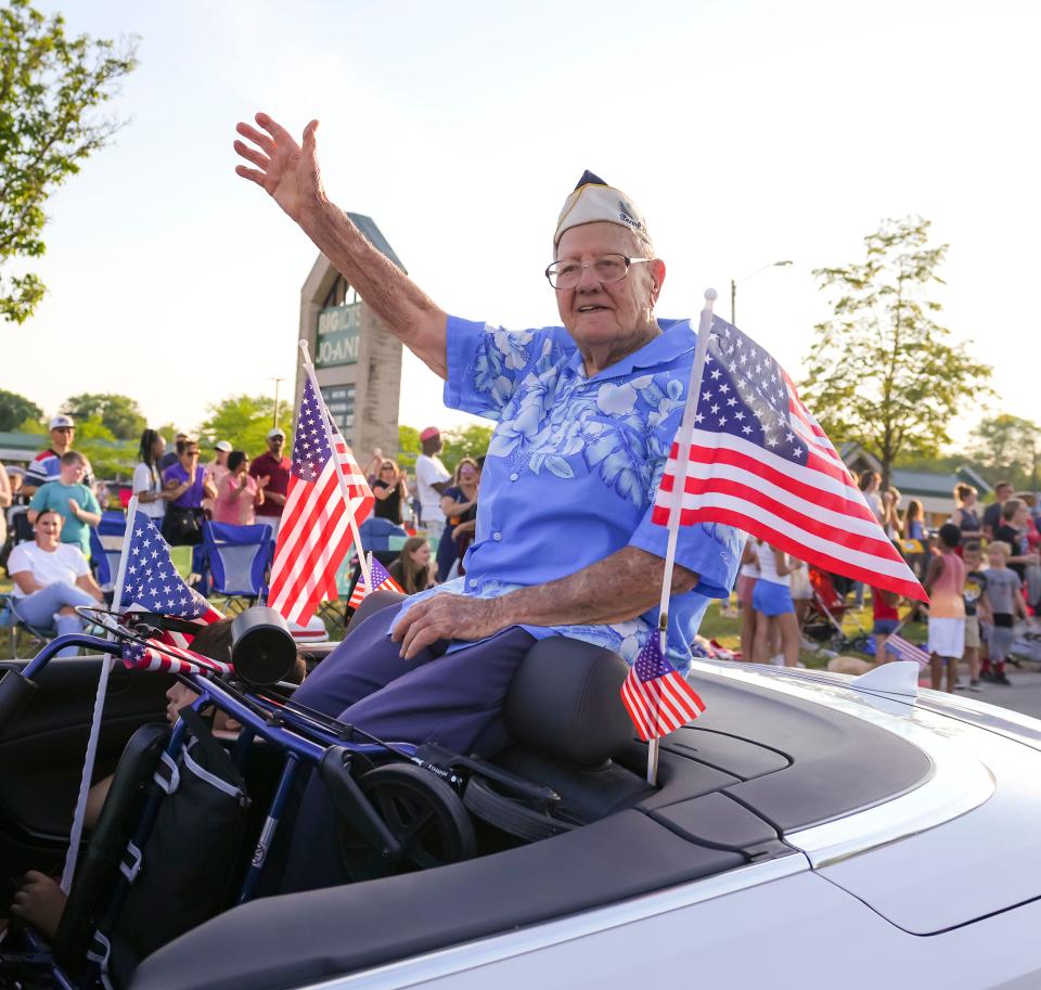 Pearl Harbor survivor Edward Miklavcic, a veteran of the then U.S. Army Air Forces, rides in the annual Menomonee Falls Independence Day parade on Sunday, July 3, 2022.