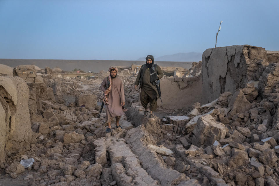 Taliban fighters guard at the site of an earthquake in Zenda Jan district in Herat province, of western Afghanistan, Sunday, Oct. 8, 2023. Powerful earthquakes killed at least 2,000 people in western Afghanistan, a Taliban government spokesman said Sunday. It's one of the deadliest earthquakes to strike the country in two decades. (AP Photo/Ebrahim Noroozi)