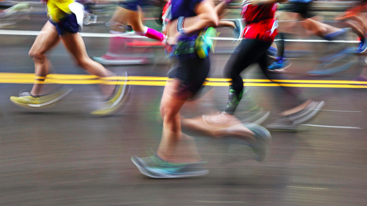  Blurred Action Of Marathon Runners On City Street. 