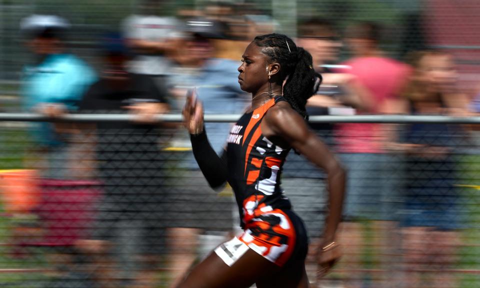 Lisa Raye of the West Warwick takes a big lead in her 100m heat and then won in the finals for the Wizards.