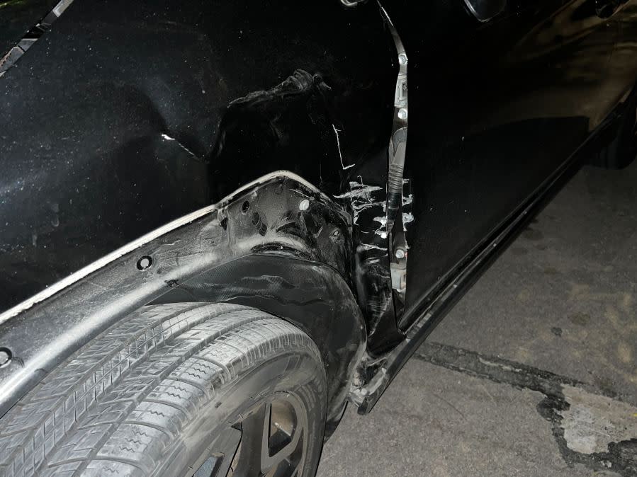 Damage to cars, street signs, etc. along East 9th Street near Embassy Drive after an 18-wheeler crashed into 10 parked vehicles overnight April 22, 2024 (KXAN Photo/Todd Bailey)