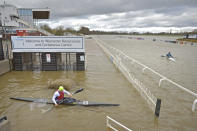 Members of Worcester Canoe Club paddle on the flooded horse race course at Worcester Racecourse, England, Sunday Feb. 23, 2020. Stormy weather continues to batter west and northern England bringing further flooding to already sodden communities. (Jacob King/PA via AP)