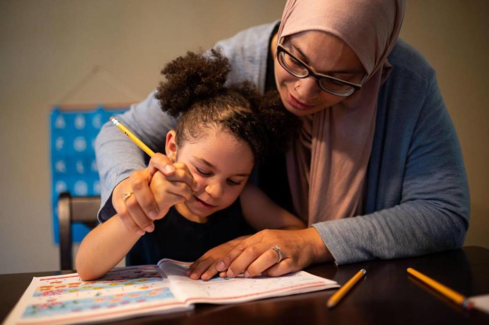 Safiya, 4, gets help from her mother, Laila Barakat, with writing her numbers during a review session Friday, July 17, 2020, in Elk Grove. Barakat and husband Abdullah Mourad spent months researching and learning about homeschooling in preparation for adopting the practice for their household.