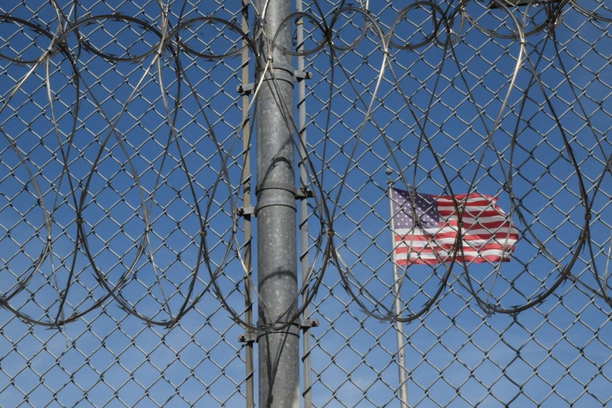 The American flag seen behind barbed wire at Holman Correctional Facility on Oct. 22, 2019.