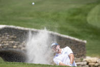 David Skinns, of England, hits out of the bunker on the 18th hole during the second round of the AT&T Byron Nelson golf tournament in McKinney, Texas, on Friday, May 13, 2022. (AP Photo/Emil Lippe)