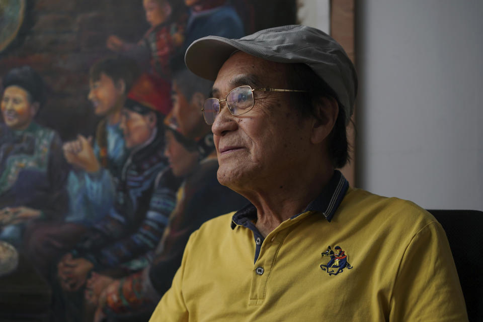 Zeng Fanzhi, a retired architect turned artist, pauses during an interview at his studio in Shenzhen in southern China's Guangdong province, Tuesday, Oct. 24, 2023. Zeng painted stark, realist portrayals of life in China under zero-COVID, saying he did so to capture a unique moment in history. (AP Photo/Dake Kang)